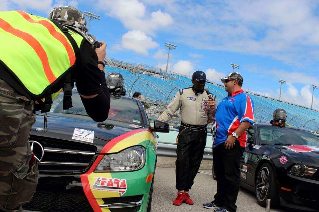 Jamaican Race Car Driver Victor Haye being interviewed before a race 