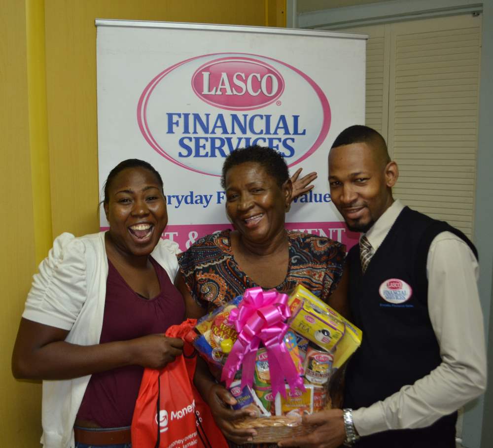 Photo Caption (L-R) 3rd place winner Georgia Crawford is all smiles as poses with her mother Lena Braham Crawford who received a lovely LASCO gift basket from Rickado Mundle (Representative of LASCO Financial Services). 